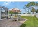 Outdoor patio area featuring a table and chairs, set on a brick surface, with views of fenced backyard at 5238 Aqua Breeze Dr, Bradenton, FL 34208