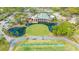 Aerial view of the clubhouse overlooking the pond, golf course and driving range at The Meadows Country Club at 5269 Wedgewood Ln # 36, Sarasota, FL 34235