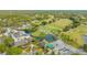 Stunning aerial view of lush golf course community with clubhouse, pools, and manicured landscaping at 5269 Wedgewood Ln # 36, Sarasota, FL 34235