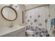 Bathroom with a gray vanity, a round mirror, and a shower with a decorative curtain at 5269 Wedgewood Ln # 36, Sarasota, FL 34235