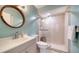 Bright bathroom featuring a glass-enclosed shower, a wooden framed mirror, and modern vanity with plenty of counter space at 5269 Wedgewood Ln # 36, Sarasota, FL 34235
