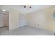 Open room with white tile flooring, ceiling fan, and bi-fold closet doors at 5269 Wedgewood Ln # 36, Sarasota, FL 34235