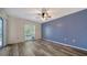 Bright bedroom with natural light, ceiling fan, and wood-look floors at 5269 Wedgewood Ln # 36, Sarasota, FL 34235