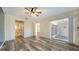 Spacious bedroom with ensuite bathroom, wood-look floors, and access to outdoor porch at 5269 Wedgewood Ln # 36, Sarasota, FL 34235