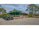 Exterior shot of the club house featuring a patio with golf carts parked out front at 5269 Wedgewood Ln # 36, Sarasota, FL 34235