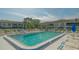 Relax by the community pool with ample seating and shaded areas amidst beautiful landscaping at 5269 Wedgewood Ln # 36, Sarasota, FL 34235