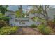 A beautifully landscaped entrance sign reads 