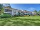 Condo exterior with screened balconies, well manicured lawn, and beautiful landscaping at 5269 Wedgewood Ln # 36, Sarasota, FL 34235