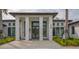 Community wellness center with elegant columns, glass doors, lush landscaping, and an inviting entrance at 5269 Wedgewood Ln # 36, Sarasota, FL 34235