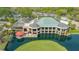 Exterior of The Meadows Country Club clubhouse with a patio on a pond and view of an island green at 5269 Wedgewood Ln # 36, Sarasota, FL 34235