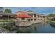 Exterior side view of The Meadows Country Club clubhouse with dining and event patio on a pond at 5269 Wedgewood Ln # 36, Sarasota, FL 34235