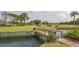 Charming wooden bridge over a small canal on a golf course with a sign that reads, Members Only at 5269 Wedgewood Ln # 36, Sarasota, FL 34235