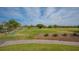 Well-manicured golf course with players, golf carts and lush green grass at 5269 Wedgewood Ln # 36, Sarasota, FL 34235