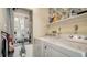 Laundry room with a white washer and dryer set, and some cleaning supplies at 5269 Wedgewood Ln # 36, Sarasota, FL 34235