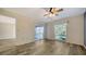 Bright living room with wood-look floors, ceiling fan and access to outdoor porch at 5269 Wedgewood Ln # 36, Sarasota, FL 34235