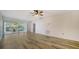 Bright living room featuring wood floors, ceiling fan, and sliding doors to screened lanai at 5269 Wedgewood Ln # 36, Sarasota, FL 34235