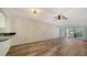 Spacious living room area with hardwood flooring, ceiling fan, and sliding glass doors at 5269 Wedgewood Ln # 36, Sarasota, FL 34235