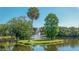 Picturesque pond featuring an island with a fountain and lush greenery, creating a tranquil setting at 5269 Wedgewood Ln # 36, Sarasota, FL 34235