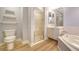 Bright bathroom with a glass-enclosed shower, a soaking tub, and shelving at 5283 Descanso Ct # 101B18, Sarasota, FL 34238
