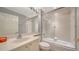 Bathroom featuring a well-lit vanity, large mirror and shower-over-tub with glass door at 5283 Descanso Ct # 101B18, Sarasota, FL 34238