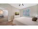 Bright bedroom featuring a ceiling fan, white dresser, and window with plantation shutters at 5283 Descanso Ct # 101B18, Sarasota, FL 34238