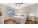 Serene bedroom features a large window, light walls, and modern wood-look flooring at 5283 Descanso Ct # 101B18, Sarasota, FL 34238