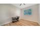 Bright bedroom with wood-look flooring, ceiling fan, and large shuttered window at 5283 Descanso Ct # 101B18, Sarasota, FL 34238