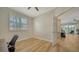 Bedroom with wood-look floors, ceiling fan, and window view of outdoor patio at 5283 Descanso Ct # 101B18, Sarasota, FL 34238