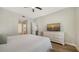 Well-lit bedroom showcases a TV on a white dresser and an en-suite bathroom at 5283 Descanso Ct # 101B18, Sarasota, FL 34238