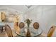 Cozy dining area with views, chandelier and seating for four at 5283 Descanso Ct # 101B18, Sarasota, FL 34238