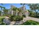 Beautiful exterior showcasing lush landscaping, complemented by a paver walkway and a charming, light-colored facade at 5283 Descanso Ct # 101B18, Sarasota, FL 34238