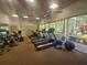 Bright fitness center featuring treadmills, elliptical machines, and free weights overlooking scenic outdoors at 5283 Descanso Ct # 101B18, Sarasota, FL 34238