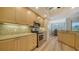 Well-lit kitchen boasts stainless steel appliances, light wood cabinetry and tile backsplash at 5283 Descanso Ct # 101B18, Sarasota, FL 34238