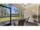 Relaxing screened lanai with comfortable seating, offering serene views of the lake and fountain at 5283 Descanso Ct # 101B18, Sarasota, FL 34238