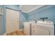 Laundry room with a washer, dryer, and overhead shelving at 5283 Descanso Ct # 101B18, Sarasota, FL 34238