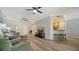 Inviting living room features ceiling fans, comfortable seating, and light, wood-look floors at 5283 Descanso Ct # 101B18, Sarasota, FL 34238