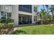 Enclosed patio with outdoor seating and view of the green lawn at 5283 Descanso Ct # 101B18, Sarasota, FL 34238