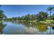 Scenic view of a pond surrounded by lush greenery and a tranquil fountain at 5283 Descanso Ct # 101B18, Sarasota, FL 34238