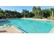 Community pool with plenty of seating with tables and chairs and well maintained landscaping at 5283 Descanso Ct # 101B18, Sarasota, FL 34238