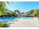 Inviting pool area with lounge chairs, tables, and cabana surrounded by tropical landscaping at 5283 Descanso Ct # 101B18, Sarasota, FL 34238