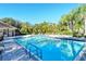 Community pool with well maintained landscaping, lounge chairs and umbrellas at 5283 Descanso Ct # 101B18, Sarasota, FL 34238
