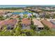 An aerial shot showcases homes with tile roofs, lush landscaping, and serene water views in a desirable neighborhood at 5503 Title Row Dr, Bradenton, FL 34210