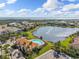 Beautiful aerial view of homes surrounding a lake with water fountains at 5503 Title Row Dr, Bradenton, FL 34210