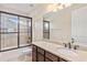 Bright bathroom featuring a shower-tub combo with glass door and vanity at 5503 Title Row Dr, Bradenton, FL 34210