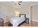 Bright bedroom featuring hardwood floors, ceiling fan, and a comfortable bed at 5503 Title Row Dr, Bradenton, FL 34210