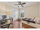 Cozy bedroom with hardwood floors, ceiling fan, and a comfortable bed at 5503 Title Row Dr, Bradenton, FL 34210