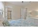Cozy bedroom with tile floors, a comfortable bed, a ceiling fan, and an ensuite bathroom at 5503 Title Row Dr, Bradenton, FL 34210