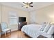 Well-lit bedroom featuring a bed, window with blinds, and hardwood floors at 5503 Title Row Dr, Bradenton, FL 34210
