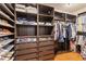 A walk-in closet with custom shelving and hardwood floors for storage at 5503 Title Row Dr, Bradenton, FL 34210