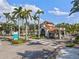 Community entrance gate with palm trees, lush landscaping, and signage at 5503 Title Row Dr, Bradenton, FL 34210